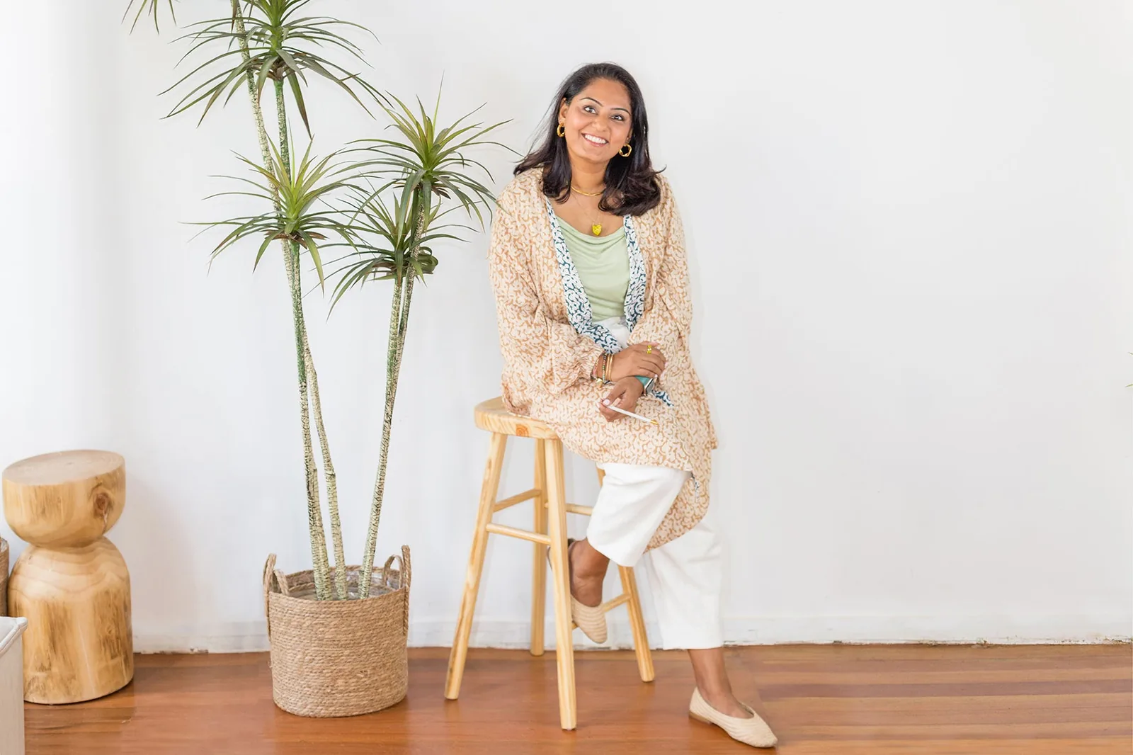 Radhika Mayani, founder of Left-handesign, seated beside indoor plants